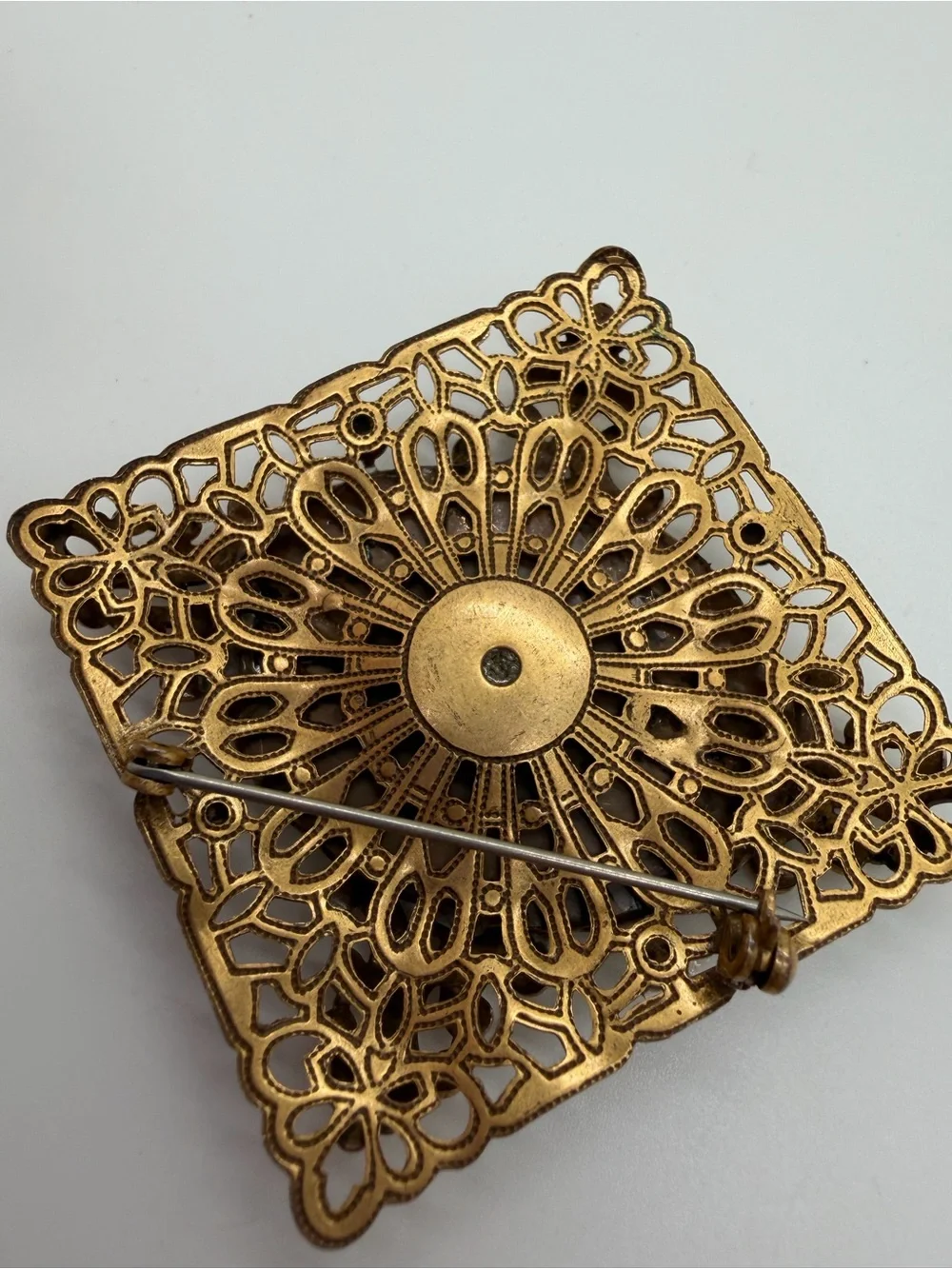 Victorian style filigree gold tone milk glass brooch